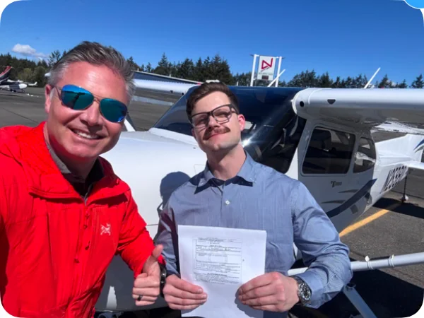 A friend with an instructor beside a small aircraft.